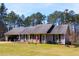 Charming single-story home with an attached garage, manicured lawn, and inviting front porch at 4841 Partee Trl, Social Circle, GA 30025