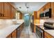 Galley kitchen boasts stone countertops, stainless appliances, and ample cabinet space at 4841 Partee Trl, Social Circle, GA 30025