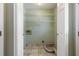 Bright laundry room features tile flooring, built-in shelving and includes hookups for a washer and dryer at 4841 Partee Trl, Social Circle, GA 30025