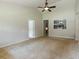 Bright, airy living room with neutral walls, ceiling fan, and carpet flooring at 4841 Partee Trl, Social Circle, GA 30025