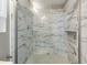 Close-up of the shower area with gray-patterned tiling and modern fixtures at 4841 Partee Trl, Social Circle, GA 30025
