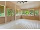 Charming sunroom with abundant natural light, featuring multiple windows, doors, and ceiling fan at 4841 Partee Trl, Social Circle, GA 30025