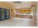 Inviting sunroom with vaulted ceilings, ceiling fan, windows and blue door leading to the exterior of the house at 4841 Partee Trl, Social Circle, GA 30025
