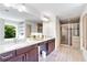 A spa-like bathroom featuring double vanity, granite countertops, and glass enclosed shower at 667 Creswell Park, Smyrna, GA 30082