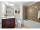 A well-lit bathroom featuring sleek fixtures, white cabinets and modern tub/shower at 667 Creswell Park, Smyrna, GA 30082