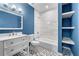 Modern bathroom features marble tiled shower and accent wall with stylish vanity and flooring at 667 Creswell Park, Smyrna, GA 30082
