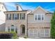 Beautiful brick front exterior features manicured landscape and two car garage at 667 Creswell Park, Smyrna, GA 30082