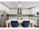 Modern kitchen with a large island, stainless steel appliances, and white cabinets at 667 Creswell Park, Smyrna, GA 30082