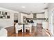 Open kitchen features stainless appliances, tile backsplash, and a dining area at 667 Creswell Park, Smyrna, GA 30082