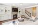 Living room showcasing stone fireplace, built-in shelving, and staircase at 667 Creswell Park, Smyrna, GA 30082