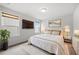 A bright bedroom with large windows, a mounted TV, and cozy decor for optimal relaxation at 667 Creswell Park, Smyrna, GA 30082