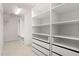 A walk-in closet with a wire shelf and white adjustable closet system that maximizes space at 667 Creswell Park, Smyrna, GA 30082