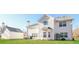 Exterior view of a two-story house featuring a spacious backyard and detached garage at 122 Melrose Creek Dr, Stockbridge, GA 30281