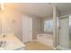 Bathroom with double sink vanity, soaking tub, shower stall, and natural light at 122 Melrose Creek Dr, Stockbridge, GA 30281