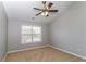 Bedroom with a ceiling fan and bright window featuring neutral walls and carpeted floors at 122 Melrose Creek Dr, Stockbridge, GA 30281
