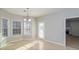 Bright dining area featuring ceramic tile floors and three large windows, offering ample natural light at 122 Melrose Creek Dr, Stockbridge, GA 30281