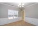 Dining room with chair rail, large window with natural light, and modern chandelier at 122 Melrose Creek Dr, Stockbridge, GA 30281