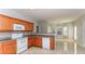 Spacious kitchen with tile flooring, wood cabinets, and a breakfast bar looking into dining area at 122 Melrose Creek Dr, Stockbridge, GA 30281