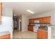 Open kitchen with tile flooring, wood cabinets, modern appliances, and convenient layout at 122 Melrose Creek Dr, Stockbridge, GA 30281