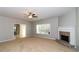 Inviting living room featuring a fireplace and a large window for natural lighting at 122 Melrose Creek Dr, Stockbridge, GA 30281