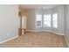 The living room features a large bay window and plush carpet at 122 Melrose Creek Dr, Stockbridge, GA 30281