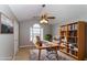 Home office featuring a ceiling fan, a work space, and a bookcase with natural light from a window at 122 Melrose Creek Dr, Stockbridge, GA 30281