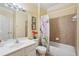 A bathroom featuring a shower/tub combo with decorative curtain, large mirror and single sink at 251 Sumac Trl, Woodstock, GA 30188