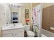 A bathroom featuring a single sink, decorative art and a shower/tub combo with tile surround at 251 Sumac Trl, Woodstock, GA 30188