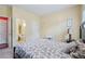 A well lit bedroom with a view of the en-suite bathroom, and a large comfortable bed at 251 Sumac Trl, Woodstock, GA 30188