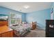 Bright blue bedroom with two beds and a window with natural light at 251 Sumac Trl, Woodstock, GA 30188