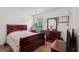 Cozy bedroom featuring a wood sleigh bed frame, dresser, and natural light from the window at 251 Sumac Trl, Woodstock, GA 30188