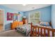 Bright blue bedroom with two beds and a window with natural light at 251 Sumac Trl, Woodstock, GA 30188