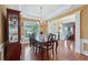 Spacious dining room with hardwood floors, a decorative chandelier, and ample natural light from the window at 251 Sumac Trl, Woodstock, GA 30188