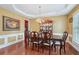 Formal dining room with hardwood floors, wainscoting, a chandelier, and a large dining table with seating at 251 Sumac Trl, Woodstock, GA 30188