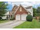 This house has a beautiful brick and vinyl exterior with an attached two car garage at 251 Sumac Trl, Woodstock, GA 30188