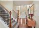 Bright foyer with hardwood floors, staircase, and entry door with sidelights, offering a welcoming entrance to the home at 251 Sumac Trl, Woodstock, GA 30188