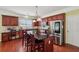 A kitchen featuring a granite countertop island with barstools, stainless steel refrigerator, and lots of storage at 251 Sumac Trl, Woodstock, GA 30188