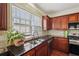 Updated kitchen featuring granite countertops, stainless steel appliances, and ample cabinet space at 251 Sumac Trl, Woodstock, GA 30188