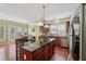 A kitchen featuring a large island with granite countertop and seating, stainless steel appliances, and ample natural light at 251 Sumac Trl, Woodstock, GA 30188