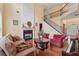 Sunlit living room showcases a fireplace, hardwood floors, and an open staircase leading to the upper level at 251 Sumac Trl, Woodstock, GA 30188