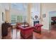 Bright living room with hardwood floors, a fireplace, two-story ceilings, and large windows with natural light at 251 Sumac Trl, Woodstock, GA 30188