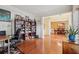 A living room with hardwood floors, a bookshelf, and a dining area visible through the opening at 251 Sumac Trl, Woodstock, GA 30188
