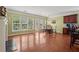 Inviting living room featuring hardwood floors, large windows, and a dining area at 251 Sumac Trl, Woodstock, GA 30188