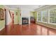 Cozy living room with hardwood floors, a fireplace, large windows, and natural light at 251 Sumac Trl, Woodstock, GA 30188