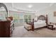 Comfortable main bedroom showcasing natural light, large windows, tray ceiling, and elegant furniture at 251 Sumac Trl, Woodstock, GA 30188