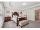 Comfortable main bedroom showcasing natural light, large windows, tray ceiling, and elegant furniture at 251 Sumac Trl, Woodstock, GA 30188