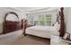 Comfortable main bedroom showcasing natural light, large windows, tray ceiling, and elegant furniture at 251 Sumac Trl, Woodstock, GA 30188