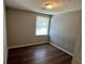 Bedroom with dark floors, neutral walls, and window bringing in natural light at 2691 Old South Dr, Jonesboro, GA 30236