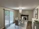 Elegant dining area featuring a modern table, fireplace, and sliding glass doors leading to the outdoor deck at 2691 Old South Dr, Jonesboro, GA 30236