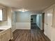 Open dining room with wood-look floors and neutral paint, adjacent to kitchen area at 2691 Old South Dr, Jonesboro, GA 30236
